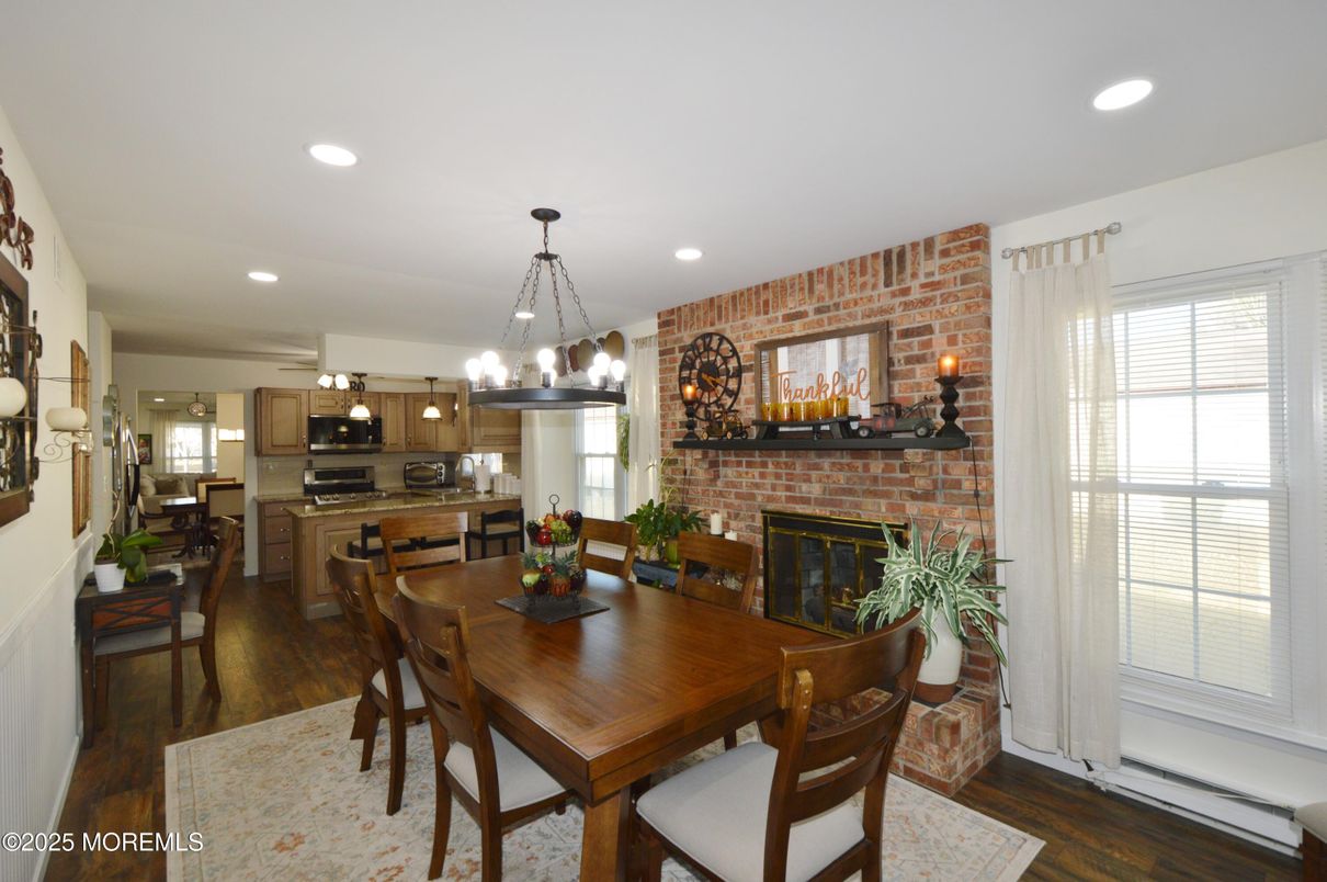 Dining room, Fireplace, Interior, Kitchen, Pendant Lights, Recessed Lighting, Stainless Steel Appliances, Stone Walls, Wood Texture Flooring