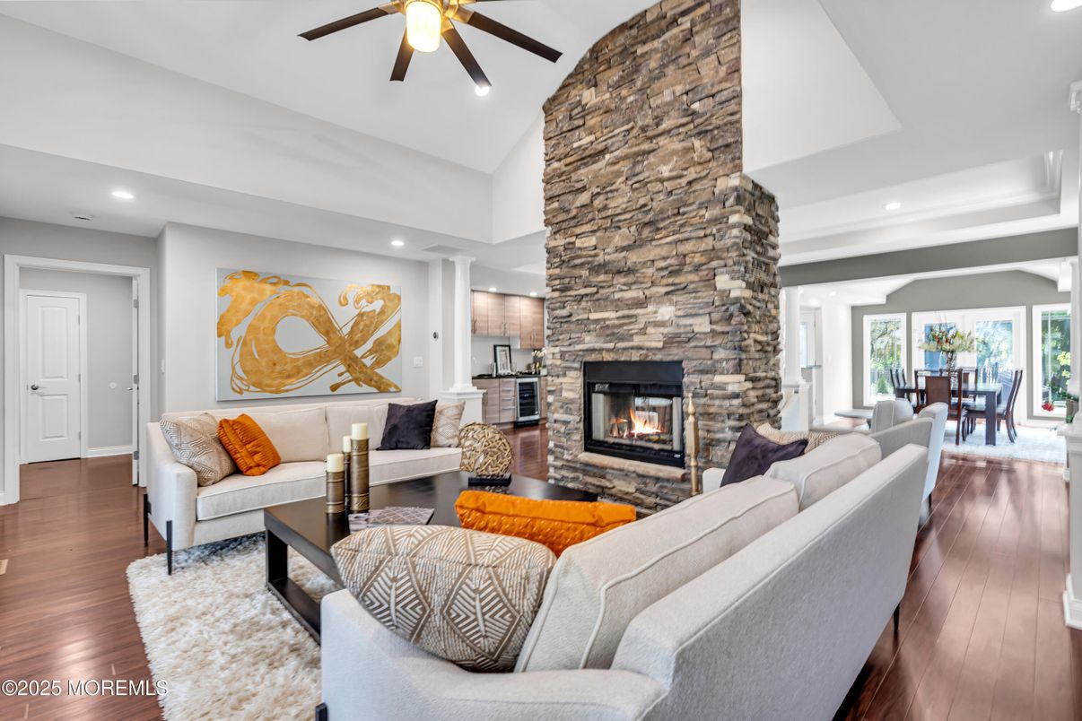 Dining room, Fireplace, Interior, Living room, Recessed Lighting, Stone Walls, Wood Texture Flooring