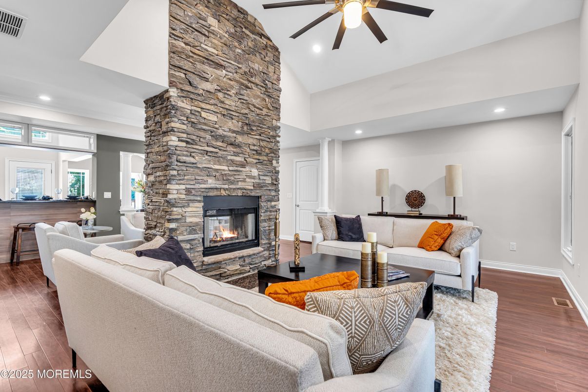 Fireplace, Interior, Living room, Recessed Lighting, Stone Walls, Wood Texture Flooring