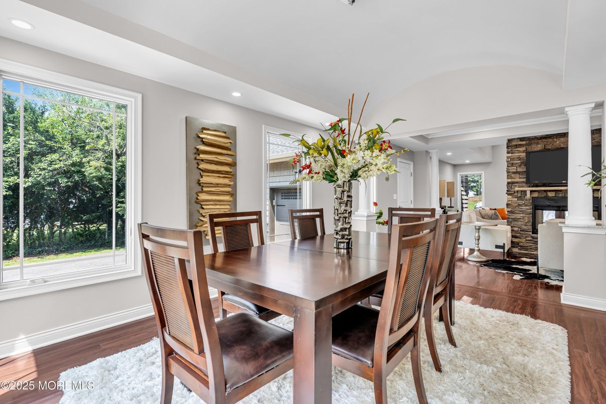 Dining room, Fireplace, Interior, Recessed Lighting, Stone Walls, Wood Texture Flooring