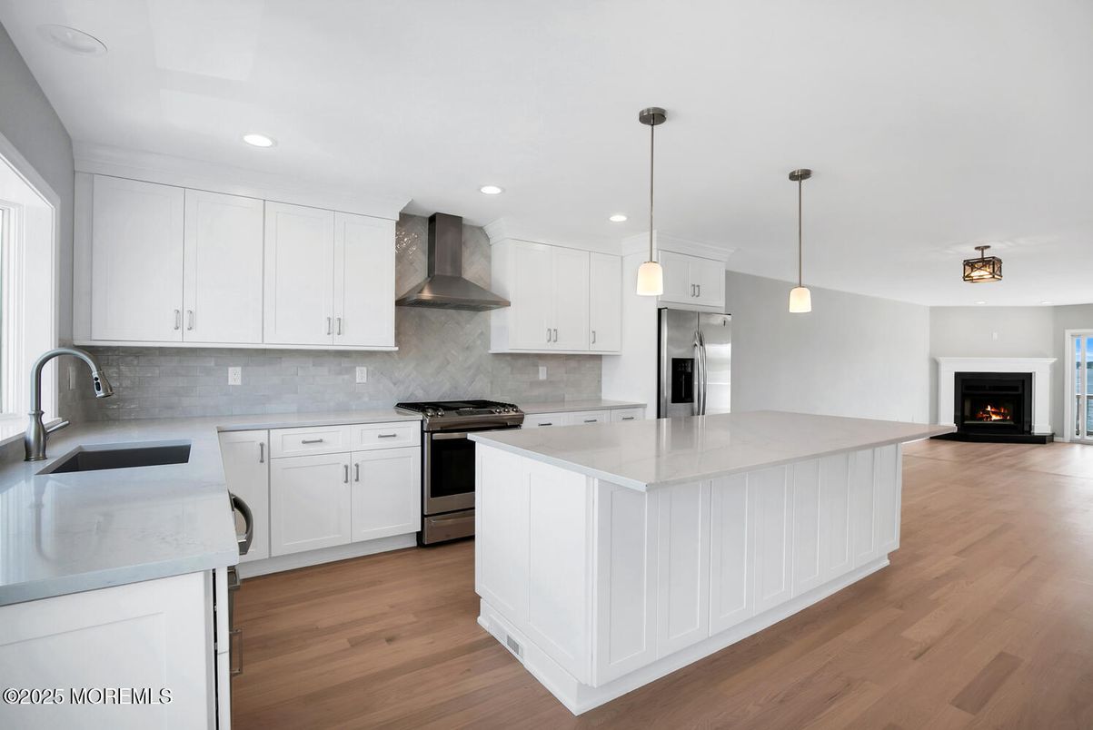Fireplace, Interior, Kitchen, Pendant Lights, Recessed Lighting, Stainless Steel Appliances, Wood Texture Flooring