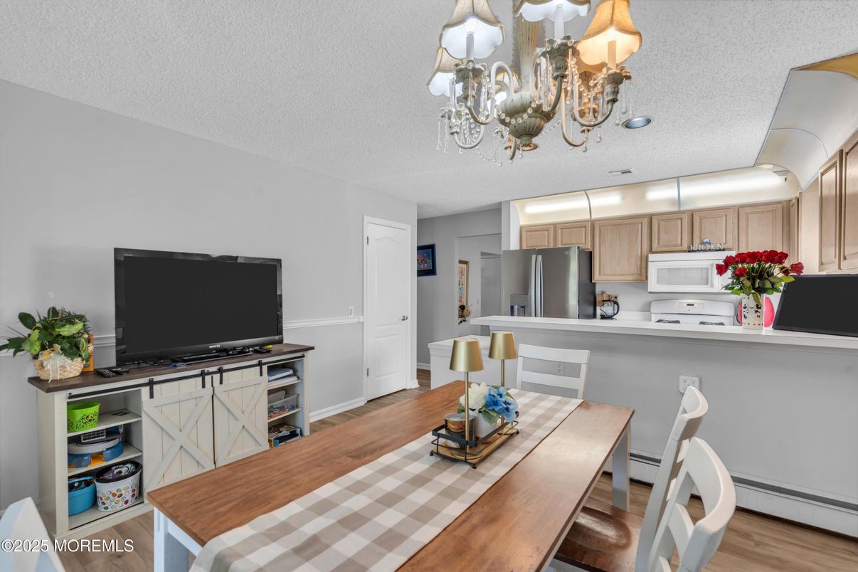 Chandelier, Dining room, Interior, Kitchen, Stainless Steel Appliances, Wood Texture Flooring