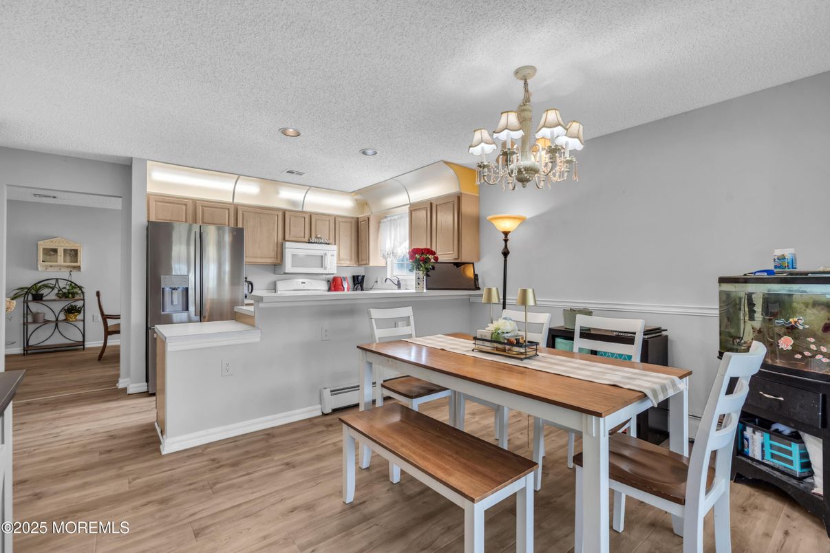 Chandelier, Dining room, Interior, Kitchen, Recessed Lighting, Stainless Steel Appliances, Wood Texture Flooring