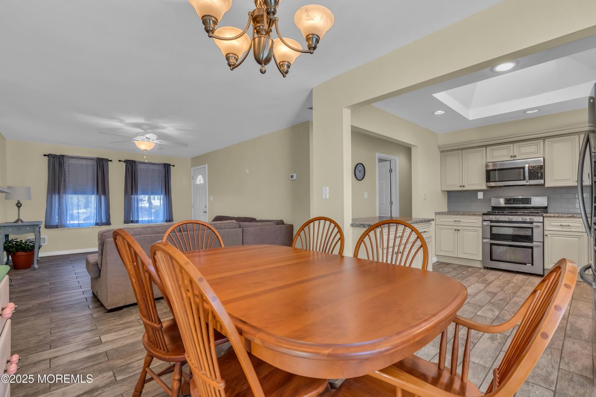 Chandelier, Dining room, Interior, Kitchen, Living room, Recessed Lighting, Stainless Steel Appliances, Wood Texture Flooring