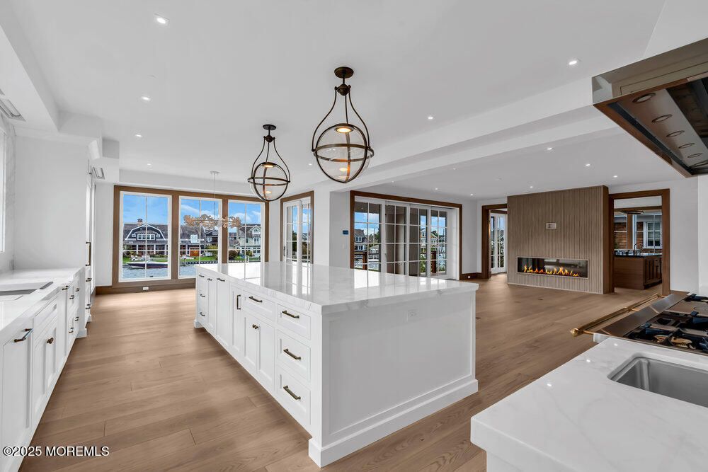 Chandelier, Fireplace, Interior, Kitchen, Pendant Lights, Recessed Lighting, Wood Texture Flooring