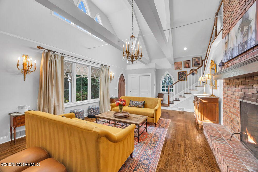 Chandelier, Fireplace, Interior, Living room, Recessed Lighting, Stone Walls, Wood Texture Flooring