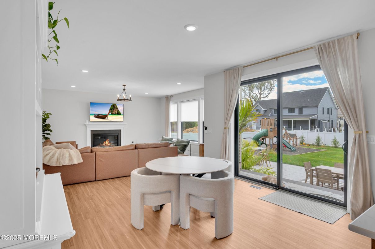Dining room, Fireplace, Interior, Living room, Pendant Lights, Recessed Lighting, Wood Texture Flooring