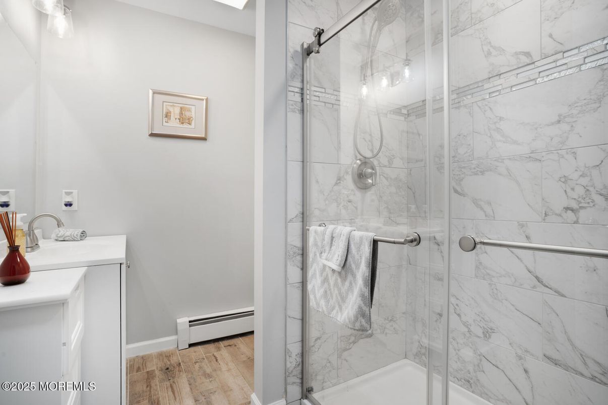 Bathroom, Glass Shower, Interior, Marble Walls, Wood Texture Flooring