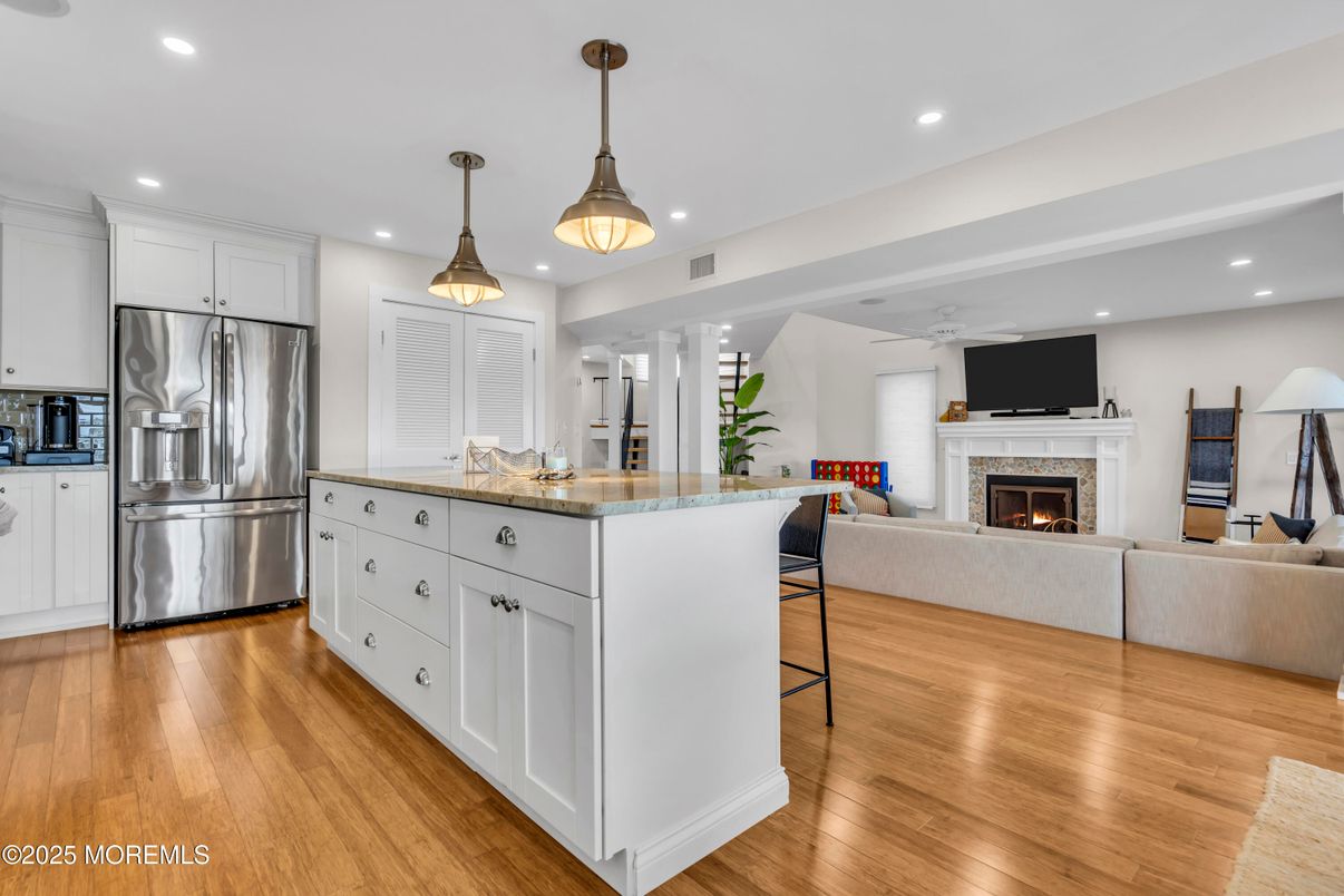 Fireplace, Interior, Kitchen, Living room, Pendant Lights, Recessed Lighting, Stainless Steel Appliances, Wood Texture Flooring