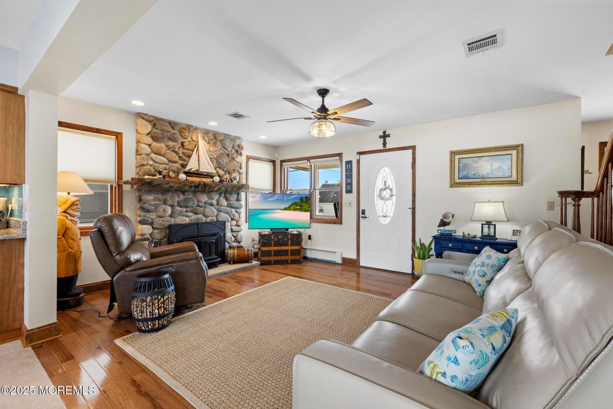 Fireplace, Interior, Living room, Recessed Lighting, Stone Walls, Wood Texture Flooring