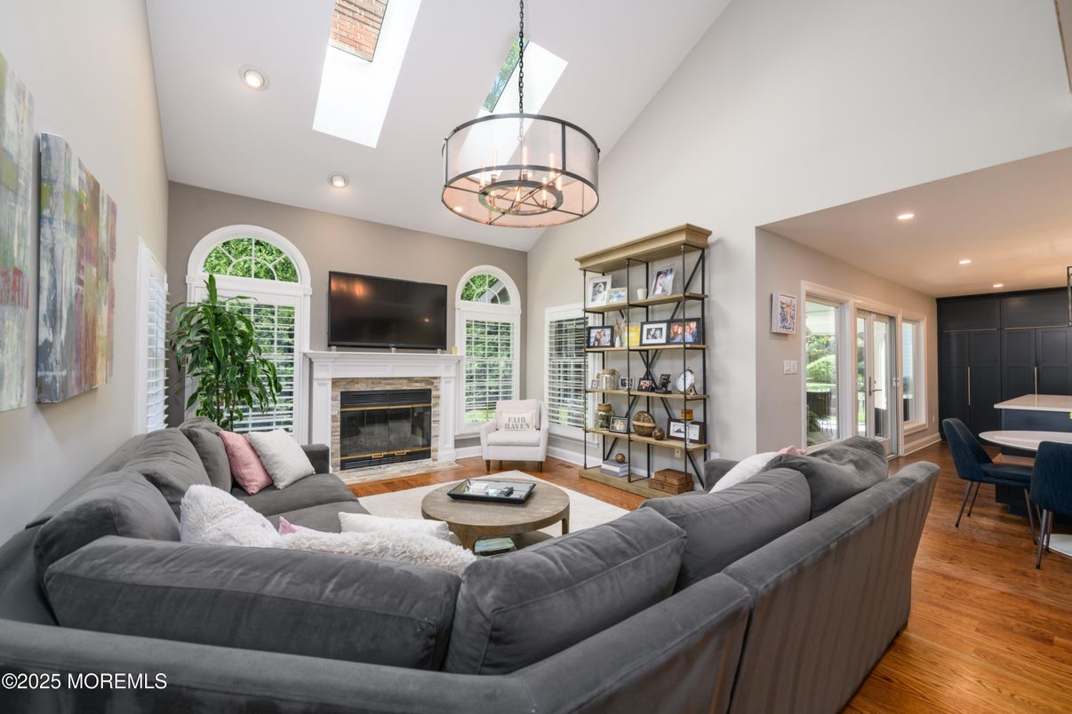 Chandelier, Dining room, Fireplace, Interior, Living room, Pendant Lights, Recessed Lighting, Wood Texture Flooring