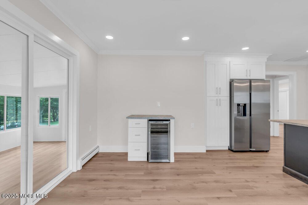 Empty room, Interior, Kitchen, Recessed Lighting, Stainless Steel Appliances, Wood Texture Flooring