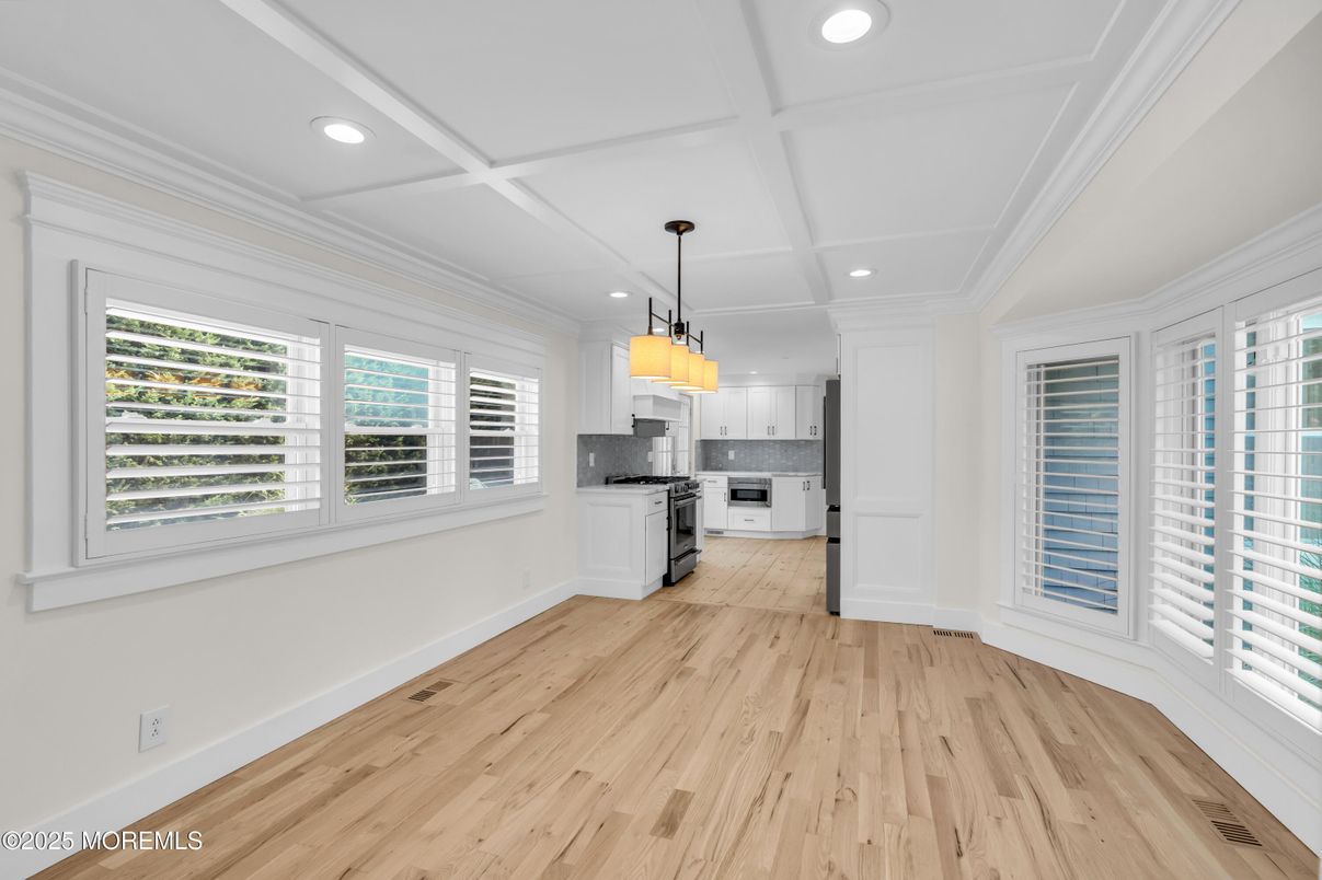 Empty room, Interior, Kitchen, Pendant Lights, Recessed Lighting, Stainless Steel Appliances, Wood Texture Flooring