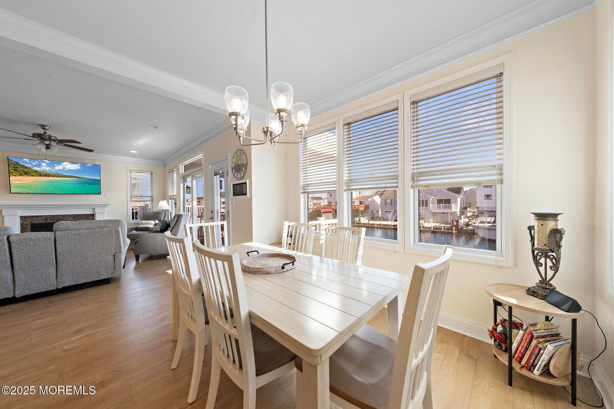 Chandelier, Dining room, Fireplace, Interior, Living room, Pendant Lights, Recessed Lighting, Wood Texture Flooring