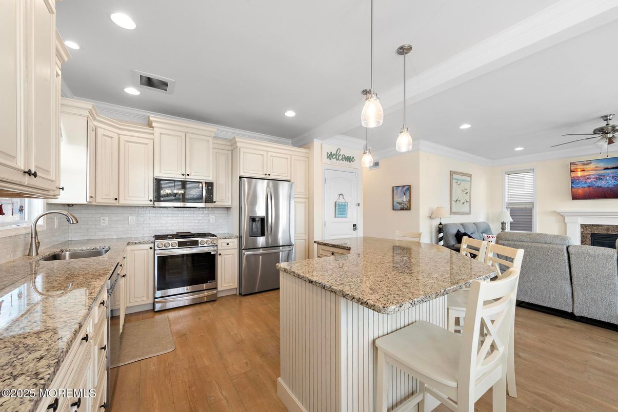Fireplace, Interior, Kitchen, Pendant Lights, Recessed Lighting, Stainless Steel Appliances, Wood Texture Flooring