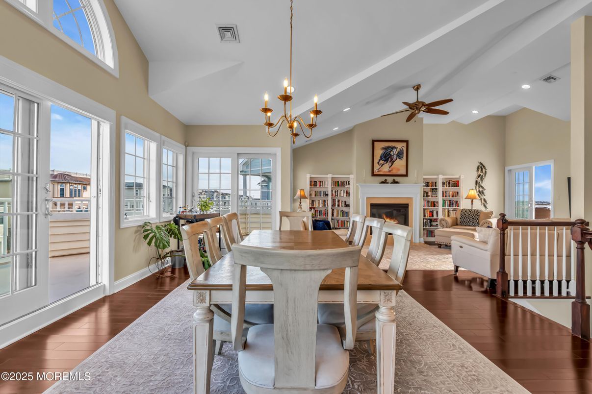 Chandelier, Dining room, Fireplace, Interior, Living room, Pendant Lights, Recessed Lighting, Wood Texture Flooring