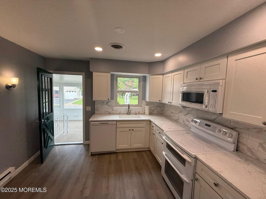 Interior, Kitchen, Marble Walls, Recessed Lighting, Stainless Steel Appliances, Wood Texture Flooring