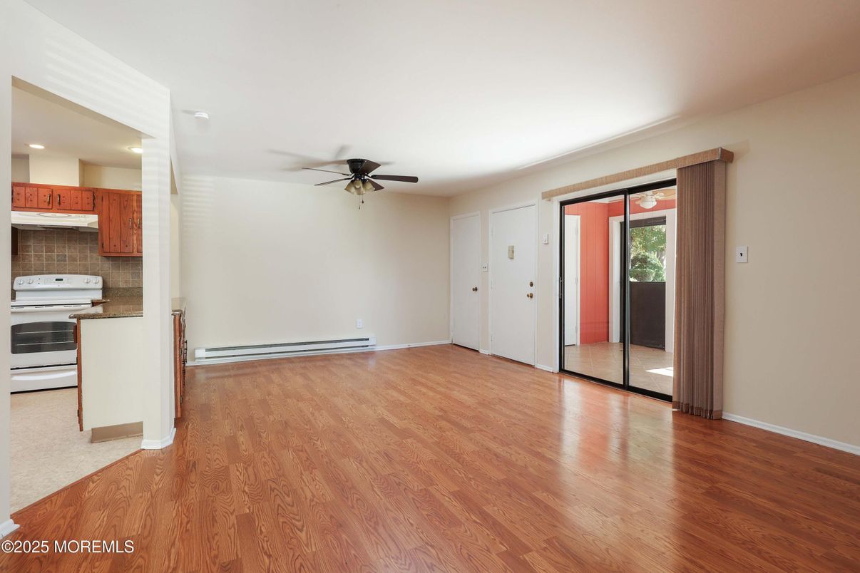 Empty room, Interior, Kitchen, Recessed Lighting, Stainless Steel Appliances, Wood Texture Flooring
