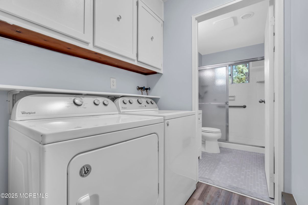 Bathroom, Glass Shower, Interior, Washer, Wood Texture Flooring
