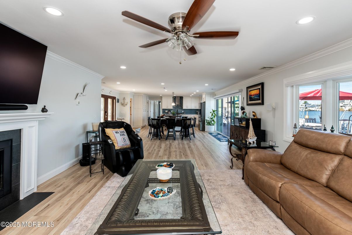 Dining room, Fireplace, Interior, Living room, Recessed Lighting, Water, Wood Texture Flooring