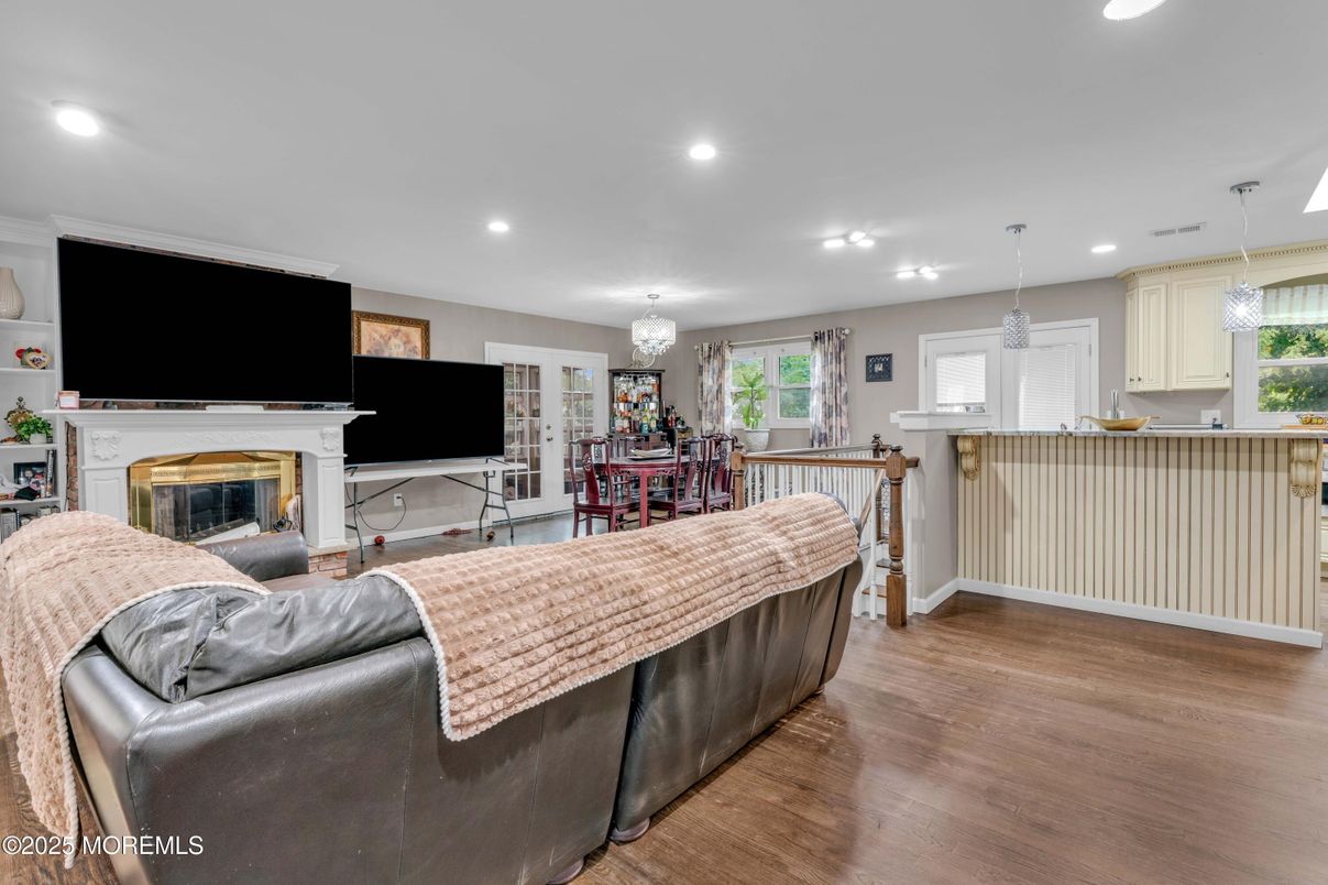 Chandelier, Dining room, Fireplace, Interior, Living room, Pendant Lights, Recessed Lighting, Wood Texture Flooring