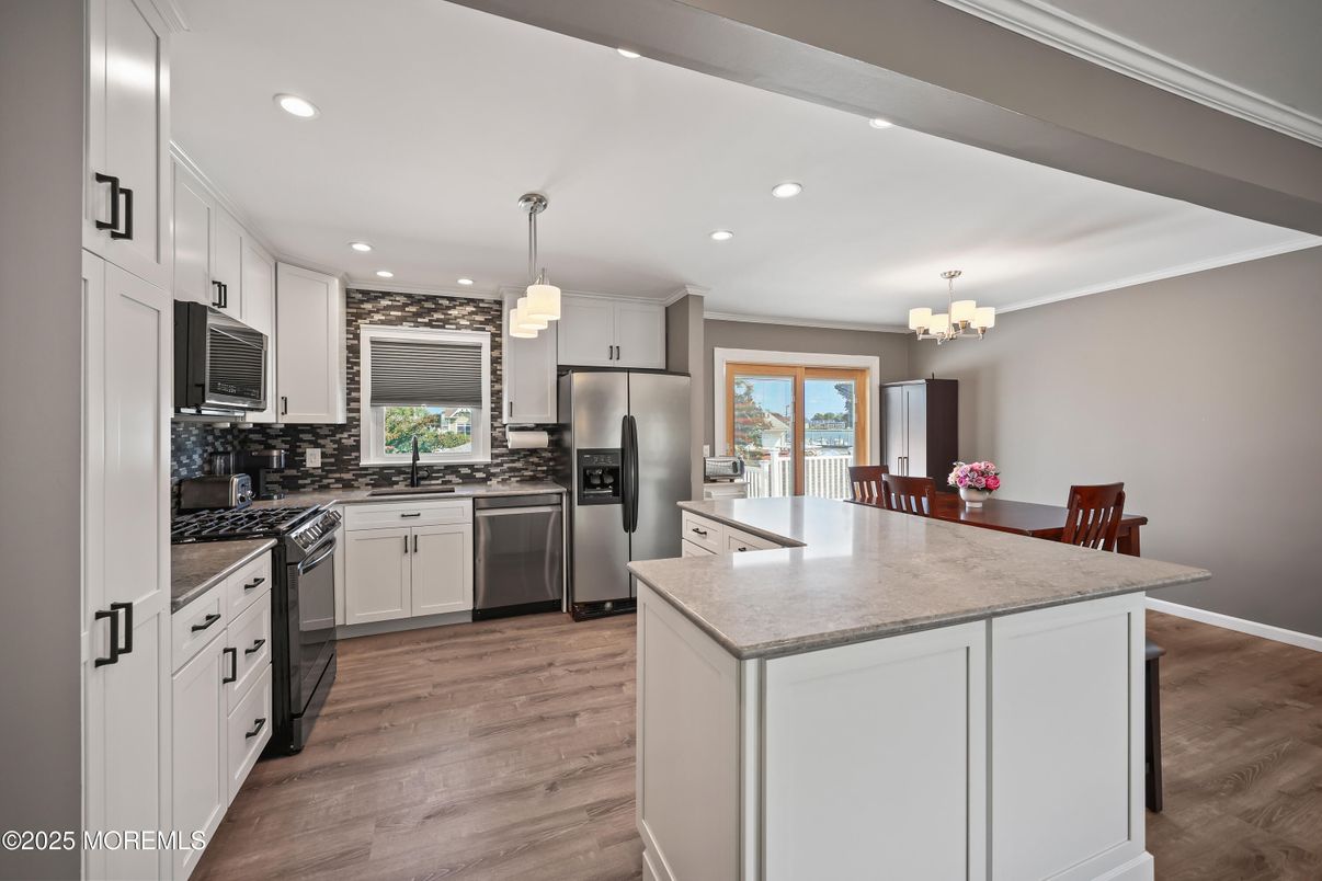 Chandelier, Dining room, Interior, Kitchen, Pendant Lights, Recessed Lighting, Stainless Steel Appliances, Wood Texture Flooring