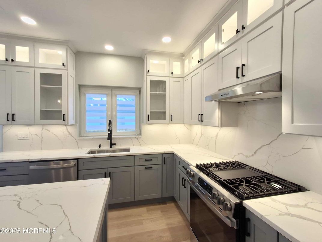 Interior, Kitchen, Marble Walls, Recessed Lighting, Stainless Steel Appliances, Wood Texture Flooring