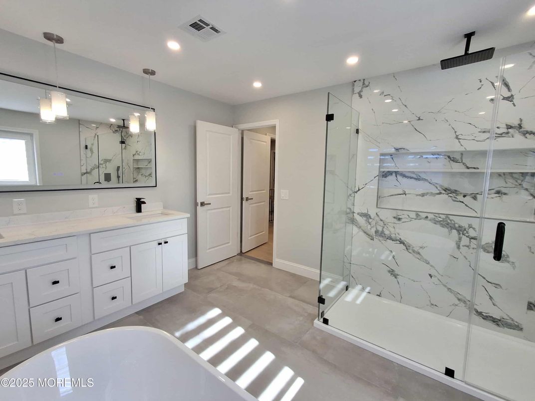 Bathroom, Dual Sink Vanities, Free Standing Baths, Glass Shower, Interior, Marble Walls, Pendant Lights, Recessed Lighting