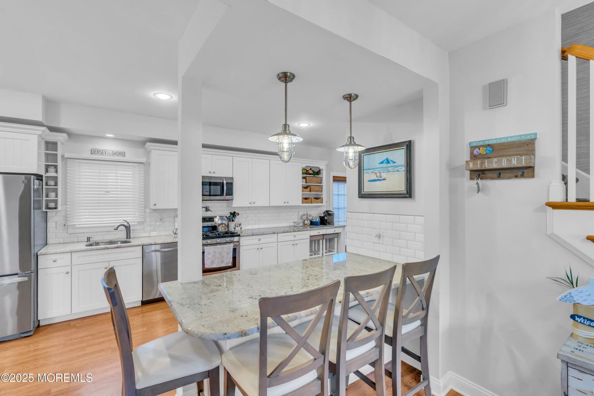 Dining room, Interior, Kitchen, Pendant Lights, Recessed Lighting, Stainless Steel Appliances, Wood Texture Flooring