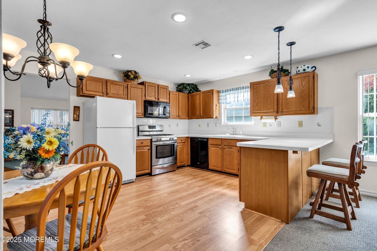 Dining room, Interior, Kitchen, Pendant Lights, Recessed Lighting, Stainless Steel Appliances, Wood Texture Flooring