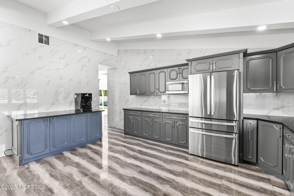 Interior, Kitchen, Marble Walls, Recessed Lighting, Stainless Steel Appliances, Wood Texture Flooring