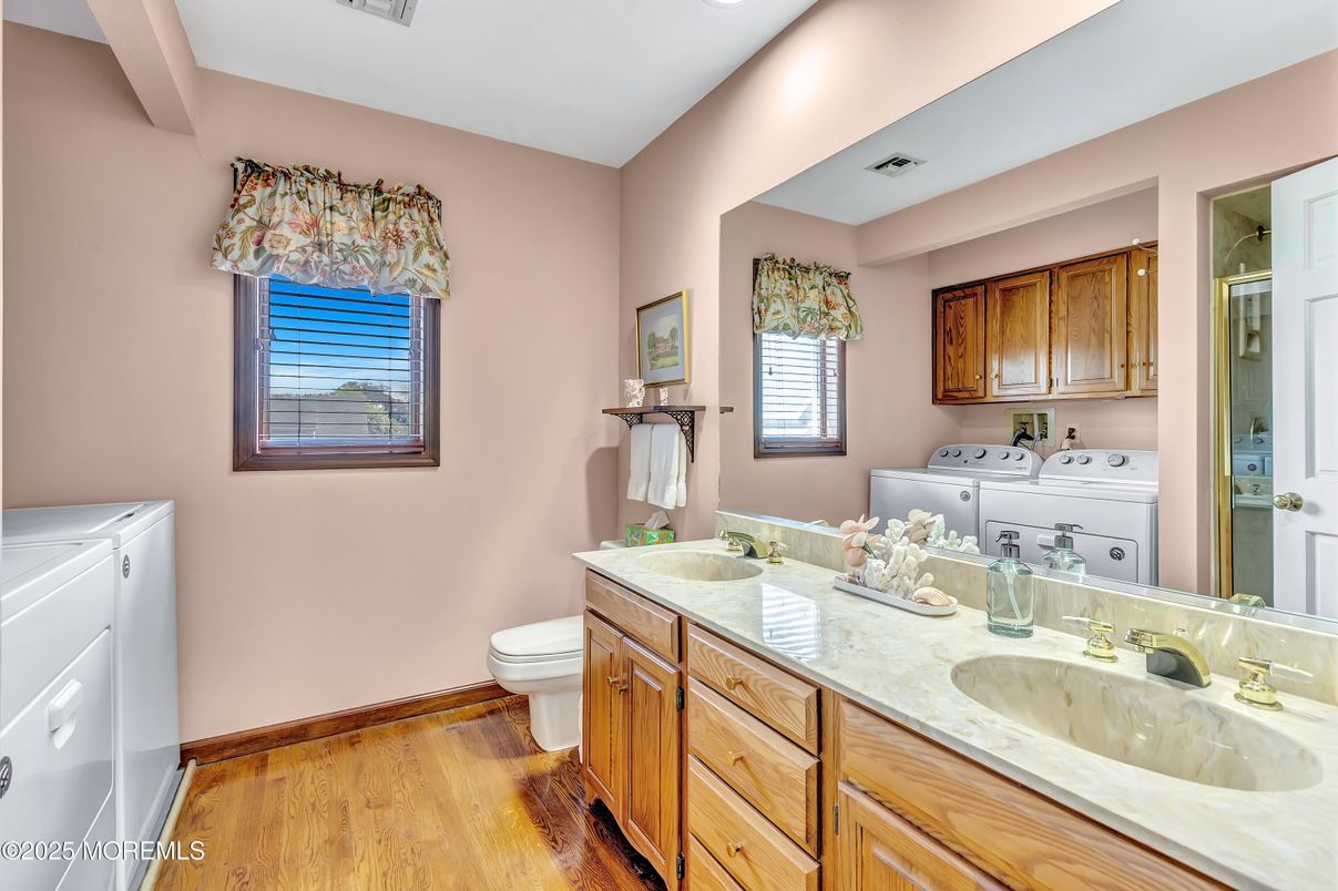 Bathroom, Dual Sink Vanities, Interior, Recessed Lighting, Washer, Wood Texture Flooring