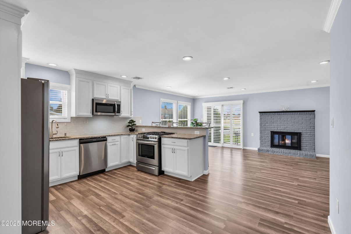 Fireplace, Interior, Kitchen, Recessed Lighting, Stainless Steel Appliances, Wood Texture Flooring