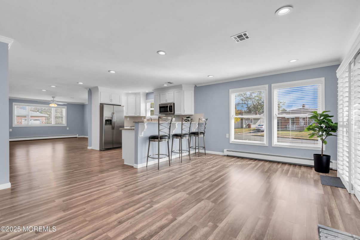 Empty room, Interior, Kitchen, Recessed Lighting, Stainless Steel Appliances, Wood Texture Flooring