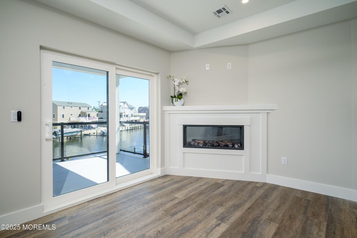 Empty room, Fireplace, Interior, Recessed Lighting, Water, Wood Texture Flooring