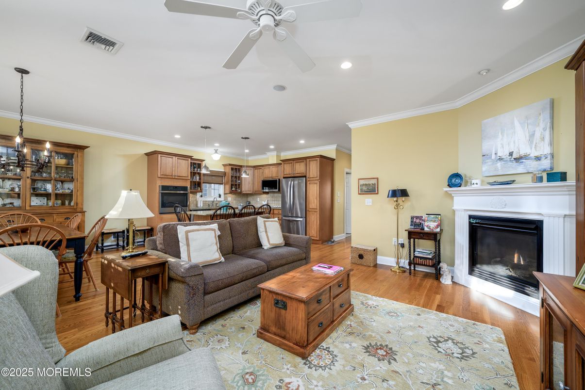 Dining room, Fireplace, Interior, Kitchen, Living room, Pendant Lights, Recessed Lighting, Stainless Steel Appliances, Wood Texture Flooring