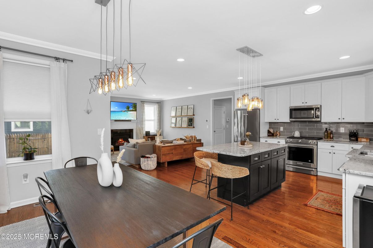 Fireplace, Interior, Kitchen, Living room, Pendant Lights, Recessed Lighting, Stainless Steel Appliances, Wood Texture Flooring