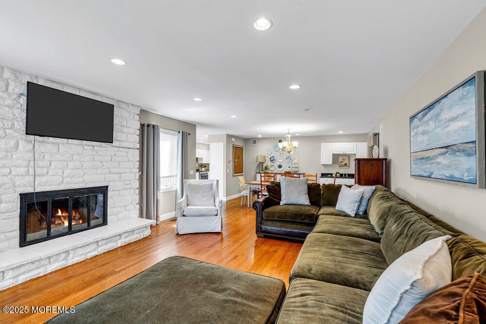 Chandelier, Dining room, Fireplace, Interior, Kitchen, Living room, Recessed Lighting, Stone Walls, Wood Texture Flooring