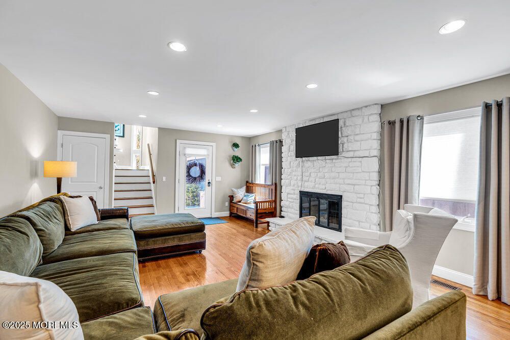 Fireplace, Interior, Living room, Recessed Lighting, Stone Walls, Wood Texture Flooring