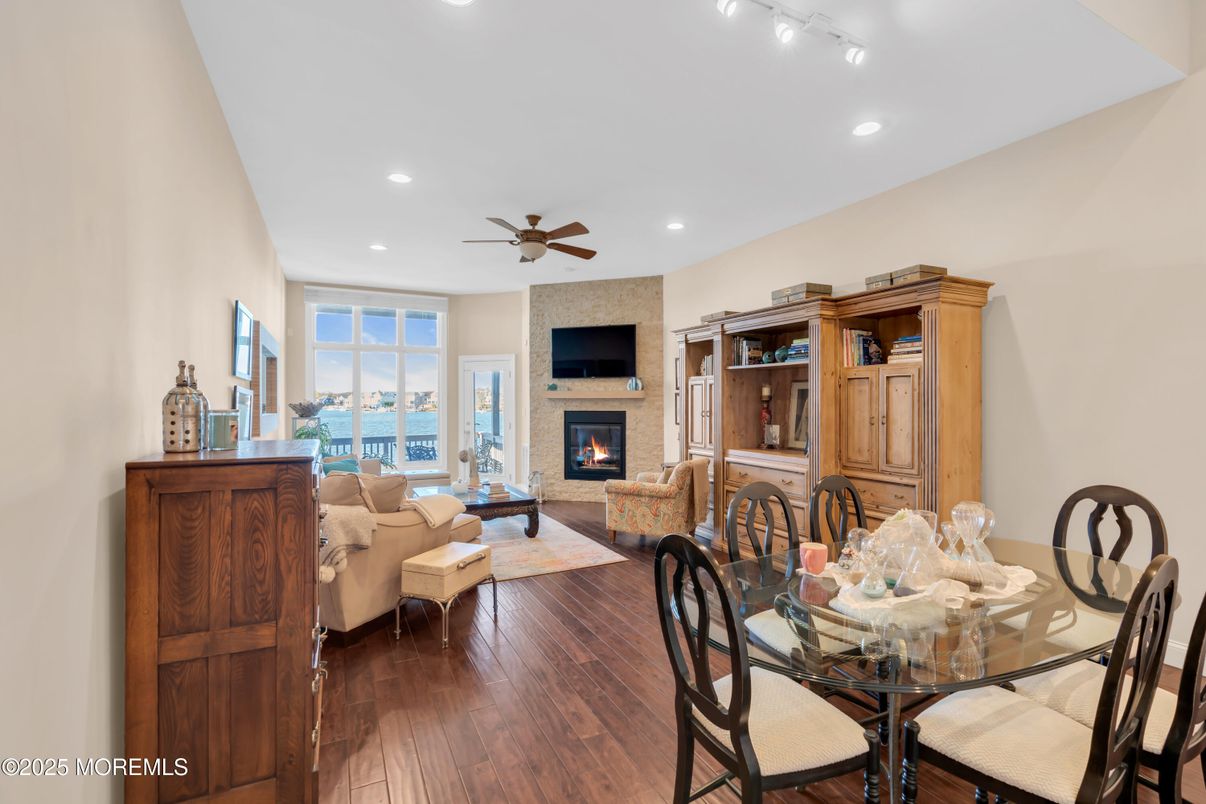 Dining room, Fireplace, Interior, Living room, Recessed Lighting, Water, Wood Texture Flooring