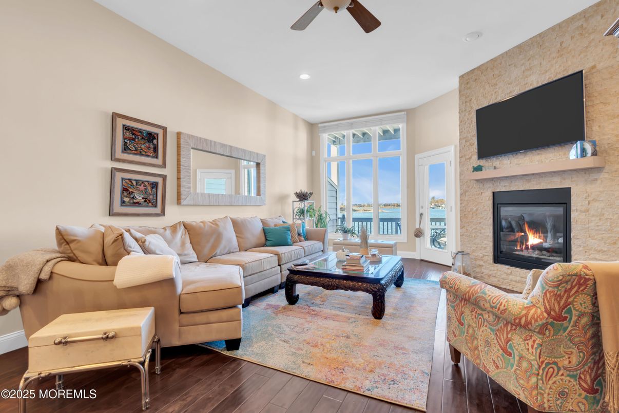 Fireplace, Interior, Living room, Recessed Lighting, Stone Walls, Water, Wood Texture Flooring