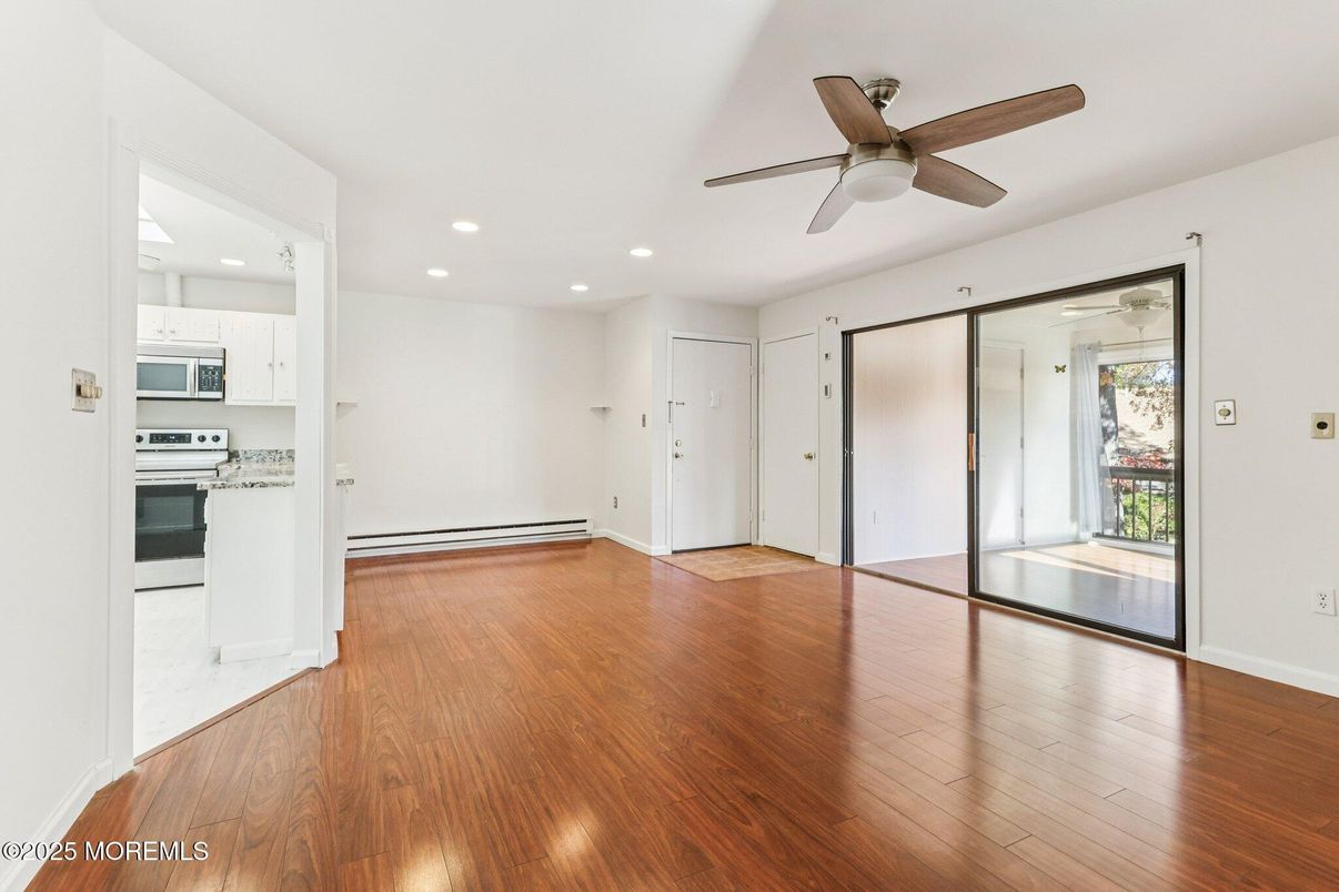 Empty room, Interior, Kitchen, Recessed Lighting, Stainless Steel Appliances, Wood Texture Flooring