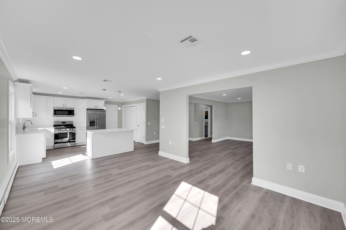 Empty room, Interior, Kitchen, Recessed Lighting, Stainless Steel Appliances, Wood Texture Flooring