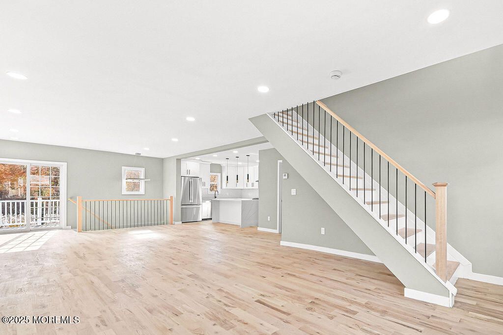 Empty room, Interior, Kitchen, Recessed Lighting, Stainless Steel Appliances, Wood Texture Flooring