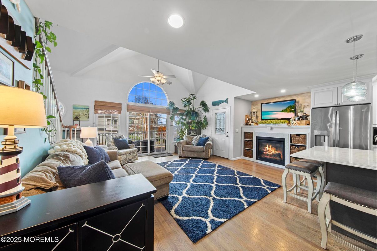 Fireplace, Interior, Kitchen, Living room, Pendant Lights, Recessed Lighting, Stainless Steel Appliances, Wood Texture Flooring