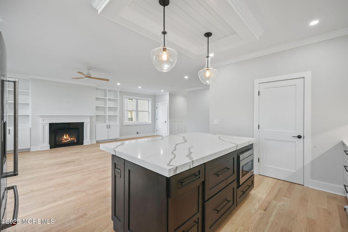 Empty room, Fireplace, Interior, Kitchen, Pendant Lights, Recessed Lighting, Wood Texture Flooring