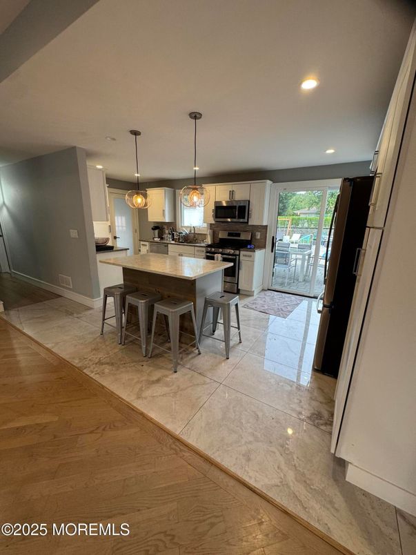 Dining room, Interior, Kitchen, Pendant Lights, Recessed Lighting, Stainless Steel Appliances, Wood Texture Flooring