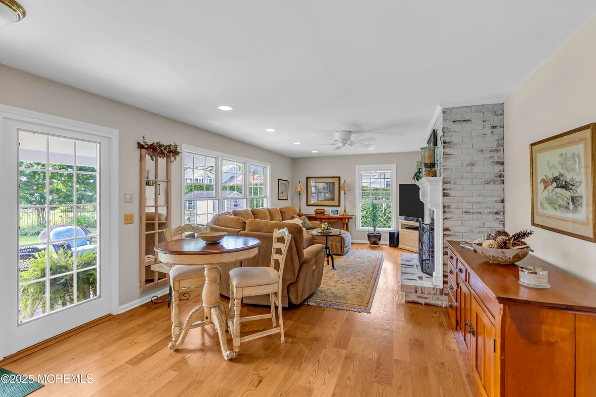 Dining room, Fireplace, Interior, Living room, Recessed Lighting, Wood Texture Flooring