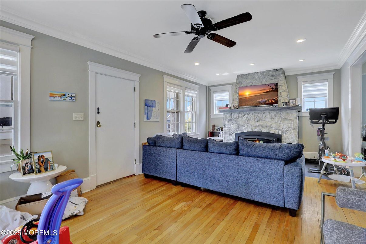 Fireplace, Fitness Equipment, Interior, Living room, Recessed Lighting, Stone Walls, Wood Texture Flooring