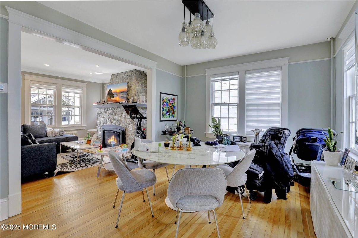 Dining room, Fireplace, Interior, Living room, Recessed Lighting, Stone Walls, Wood Texture Flooring